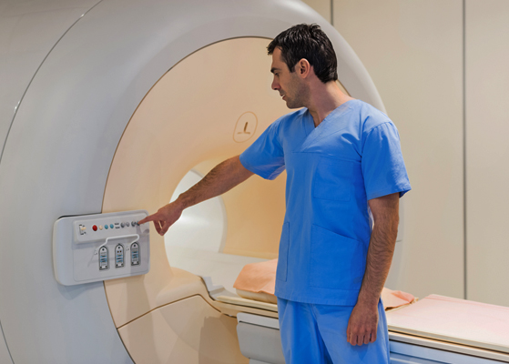 Medical technician assisting with an MRI