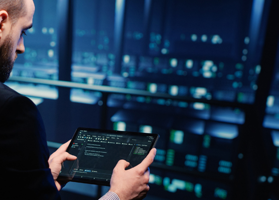 Man working on a tablet in a data center setting